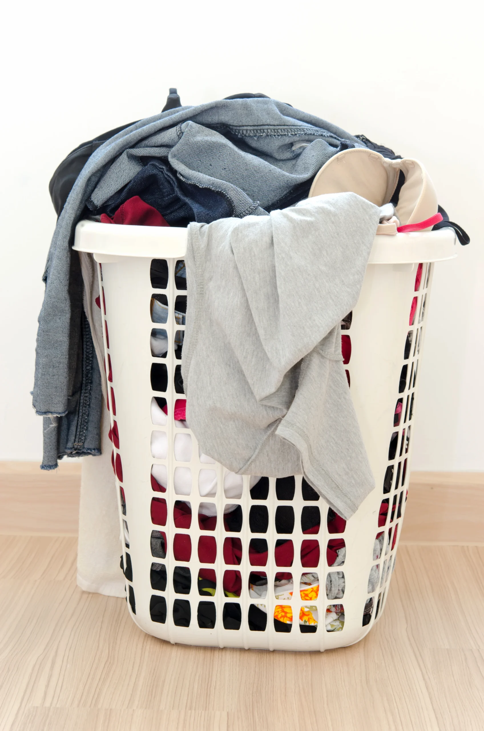 Clothes basket on floor in room.